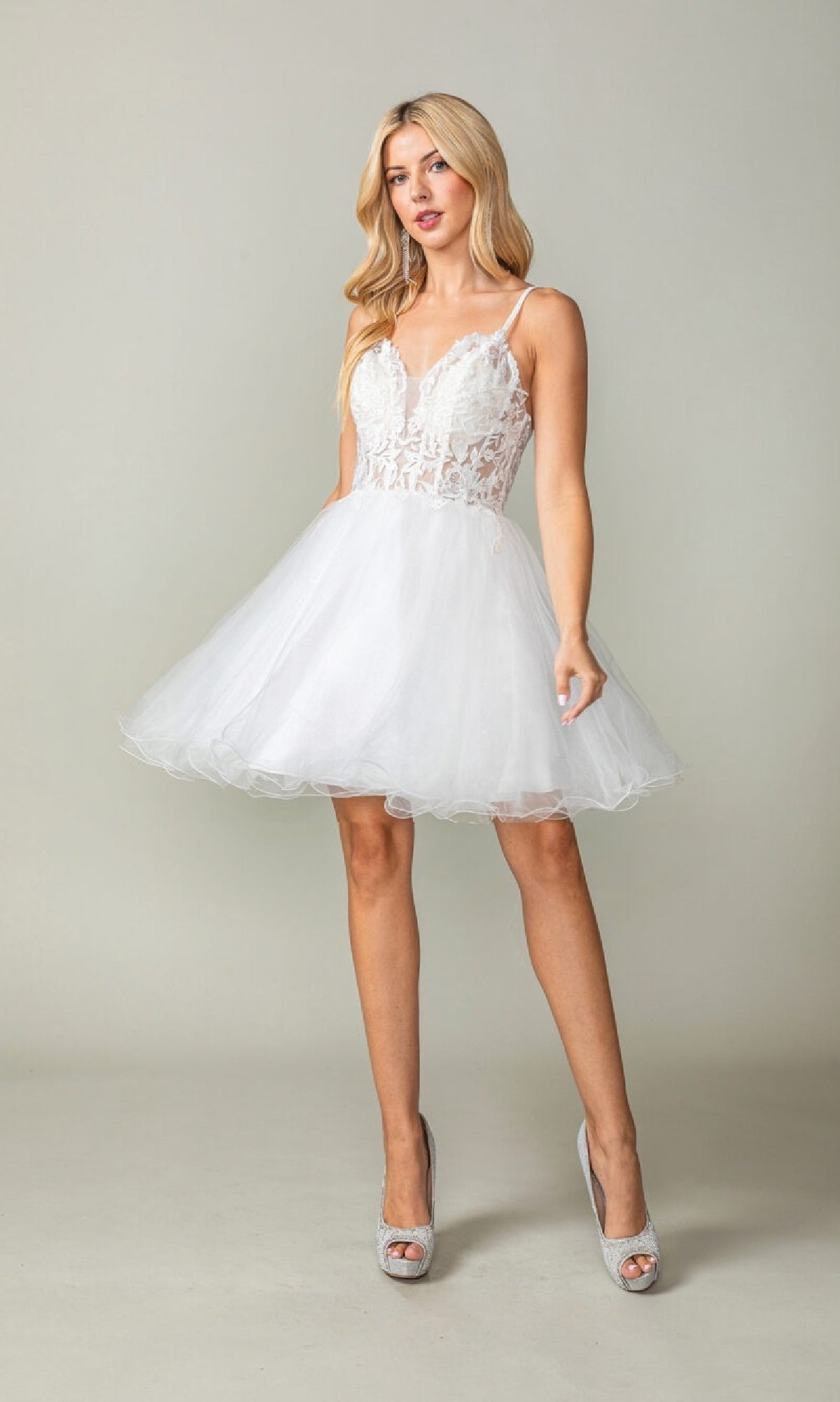 Woman wearing a white fit-and-flare short dress on a plain background